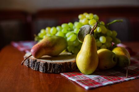 Fresh grapes and pears on a wooden table. Composition of fruits.の写真素材