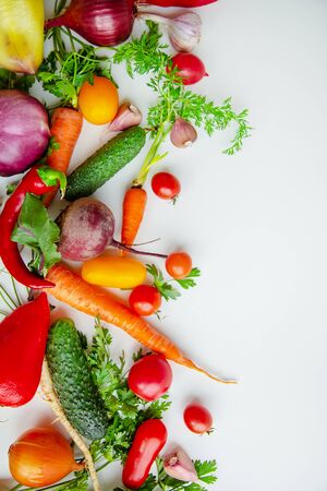 Composition with raw vegetables, tomatoes, peppers, carrots, eggplant, onions on a white background. Frame of vegetables, copy space for texts.の写真素材