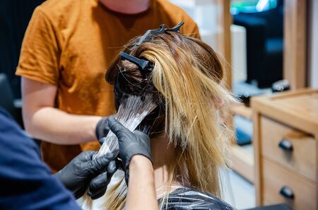 Professional hair coloring for women in the salon, bright and trendy style. Closeup strands of hair.の写真素材