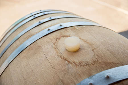Wine production. Wooden wine barrels are found at the winery. They are ready to pour or are already filled.の写真素材