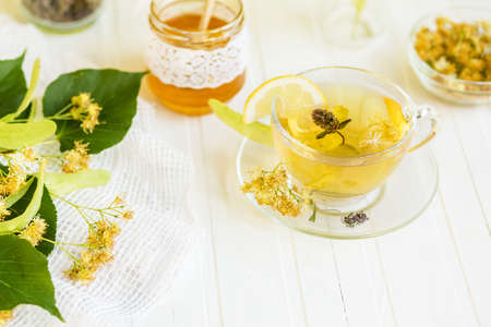 Cup of hot tea with sacking on the wooden tableの写真素材