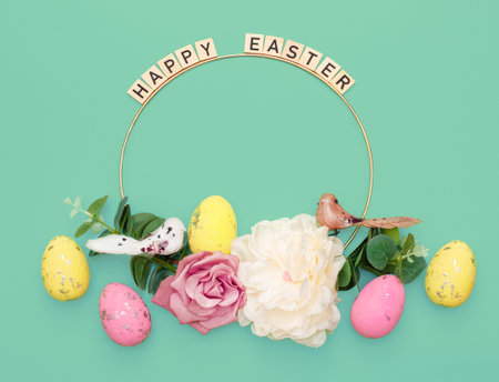 Happy Easter. Handmade Easter decor, Easter eggs and flowers on a green background. Easter wreath shapeの写真素材