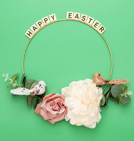 Happy Easter. Handmade Easter decor, Easter eggs and flowers on a green background. Easter wreath shapeの写真素材