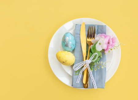 Happy Easter. Easter celebration concept. Top view vertical Napkin empty white and yellow plate,...