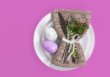 Easter celebration concept. Top view vertical Napkin empty white and yellow plate, Easter eggs, on...