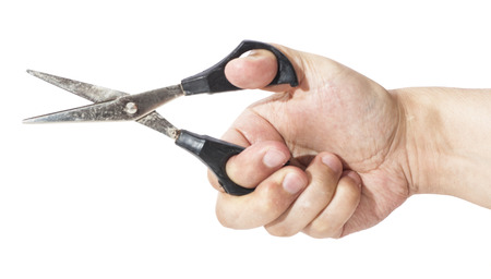 Hand is holding scissors isolated