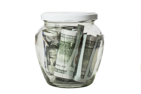 Money banknotes jar full of savings isolated on white background の写真素材