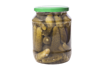 Jar of Green pickled cucumber marinated on white background の写真素材