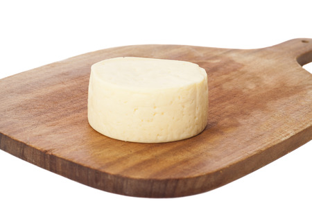 round cheese on wooden board, isolated の写真素材