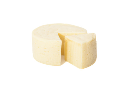 Wheel of traditional cheese isolated on white の写真素材