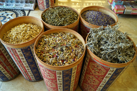 dried herbs in colored barrelsの写真素材