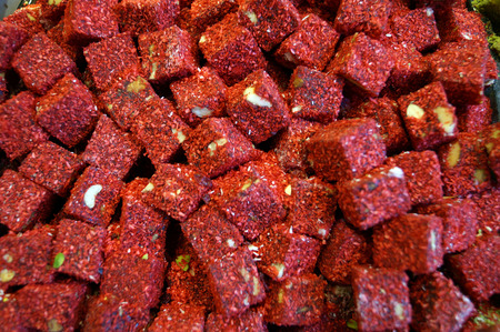 sweet cubes of nougat with pistachios in a red coconut flakesの写真素材