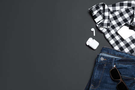 Flat lay composition with stylish men's clothes and accessories on black background, space for text