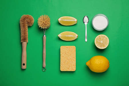 Cleaning supplies for washing dishes on green background, flat layの写真素材