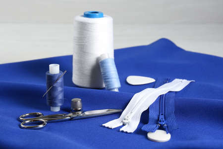 Composition with different sewing supplies on blue fabricの写真素材