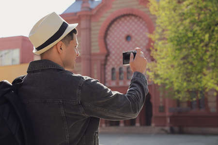 Tourist taking picture on beautiful city street