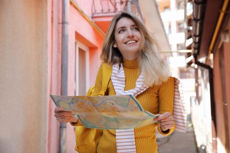 Tourist with map walking on city streetの写真素材