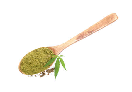 Wooden spoon with hemp protein powder and fresh leaf on white background, top viewの写真素材