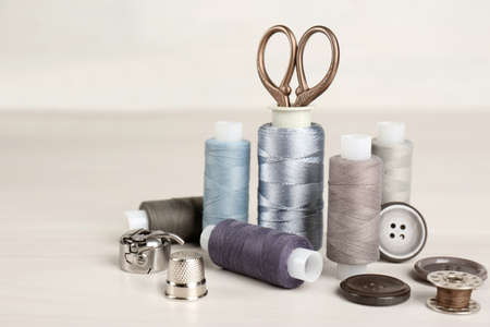 Composition with different sewing items on light beige tableの写真素材