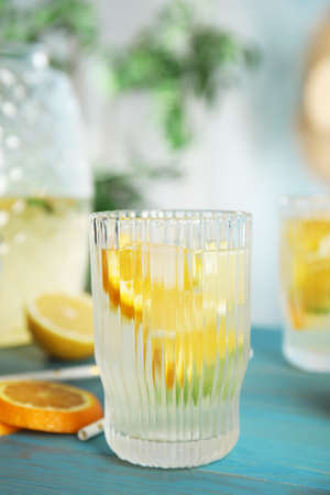 Delicious refreshing lemonade with orange slices on light blue wooden tableの写真素材