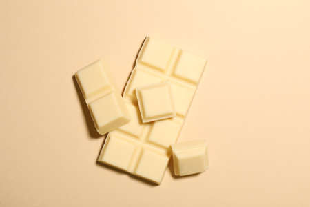 Delicious white chocolate on beige background, flat layの写真素材