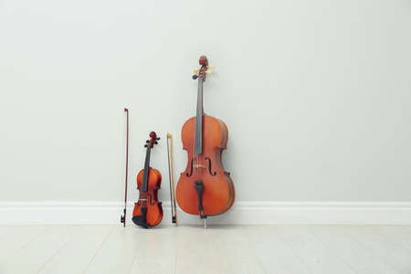 Stringed musical instruments near white wall indoorsの写真素材