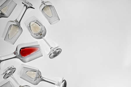 Glasses with delicious wine on white background, flat lay. Space for textの写真素材