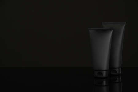 Tubes of men's facial cream on black background. Space for textの写真素材