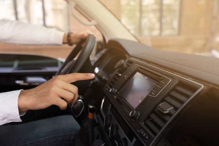 Man using navigation system while driving car, closeup