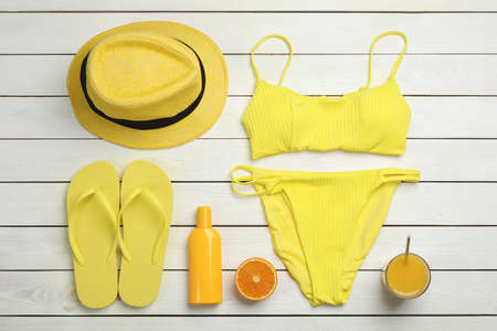 Flat lay composition with beach objects on white wooden background