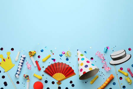 Flat lay composition with carnival items on light blue background. Space for textの写真素材