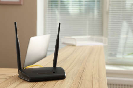 Modern  router on wooden counter indoorsの写真素材