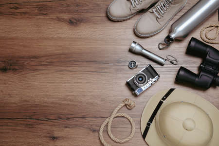 Flat lay composition with safari accessories on wooden background, space for textの写真素材