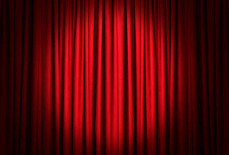Spotlight illuminating closed red stage curtains. Start of performanceの写真素材