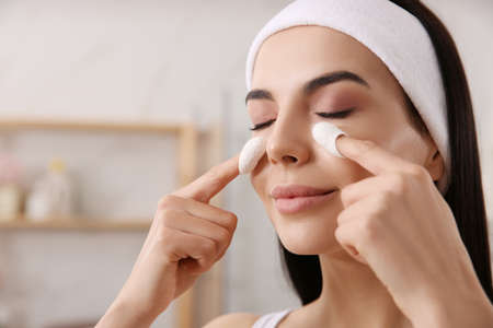 Woman using silkworm cocoons in skin care routine at home, closeupの写真素材