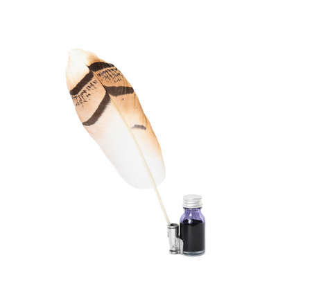 Feather pen and bottle of ink on white backgroundの写真素材