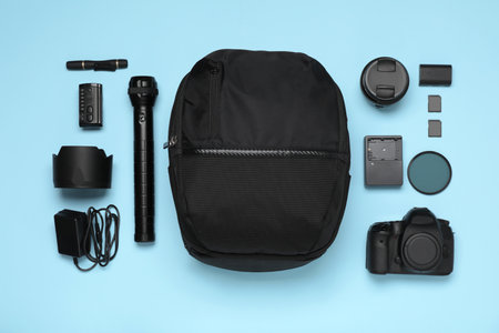 Professional photography equipment and backpack on turquoise background, flat layの写真素材