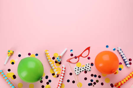 Flat lay composition with carnival items on pink background. Space for text