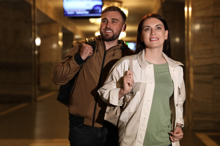 Happy couple with backpacks on subway station. Public transportの写真素材