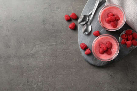 Delicious raspberry mousse served on gray table, flat lay. Space for text