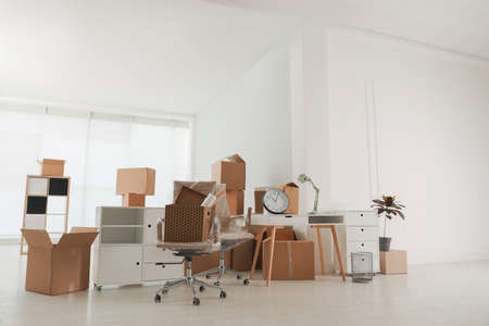 Cardboard boxes and packed stuff in office. Moving dayの写真素材