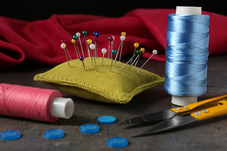 Set of sewing supplies and accessories on gray stone tableの写真素材
