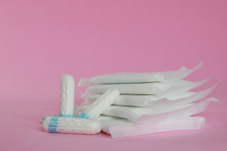 Menstrual pads and tampons on pink backgroundの写真素材