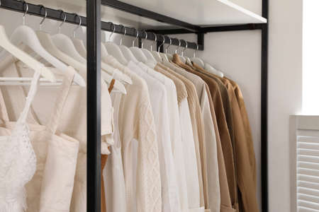 Rack with stylish women's clothes in dressing roomの写真素材