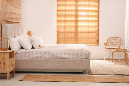 Stylish hotel room interior with comfortable bedの写真素材