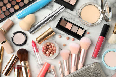 Flat lay composition with makeup products on white marble tableの写真素材