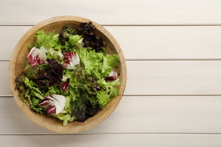 Different sorts of lettuce on white wooden table, top view. Space for textの写真素材