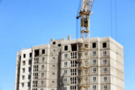 Blurred view of unfinished building and tower crane outdoorsの写真素材