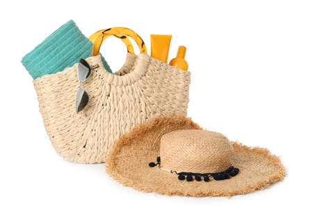 Stylish straw hat, beach bag and sunglasses on white background