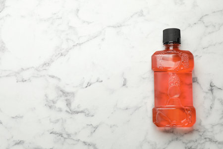 Mouthwash on white marble table, top view. Space for textの写真素材